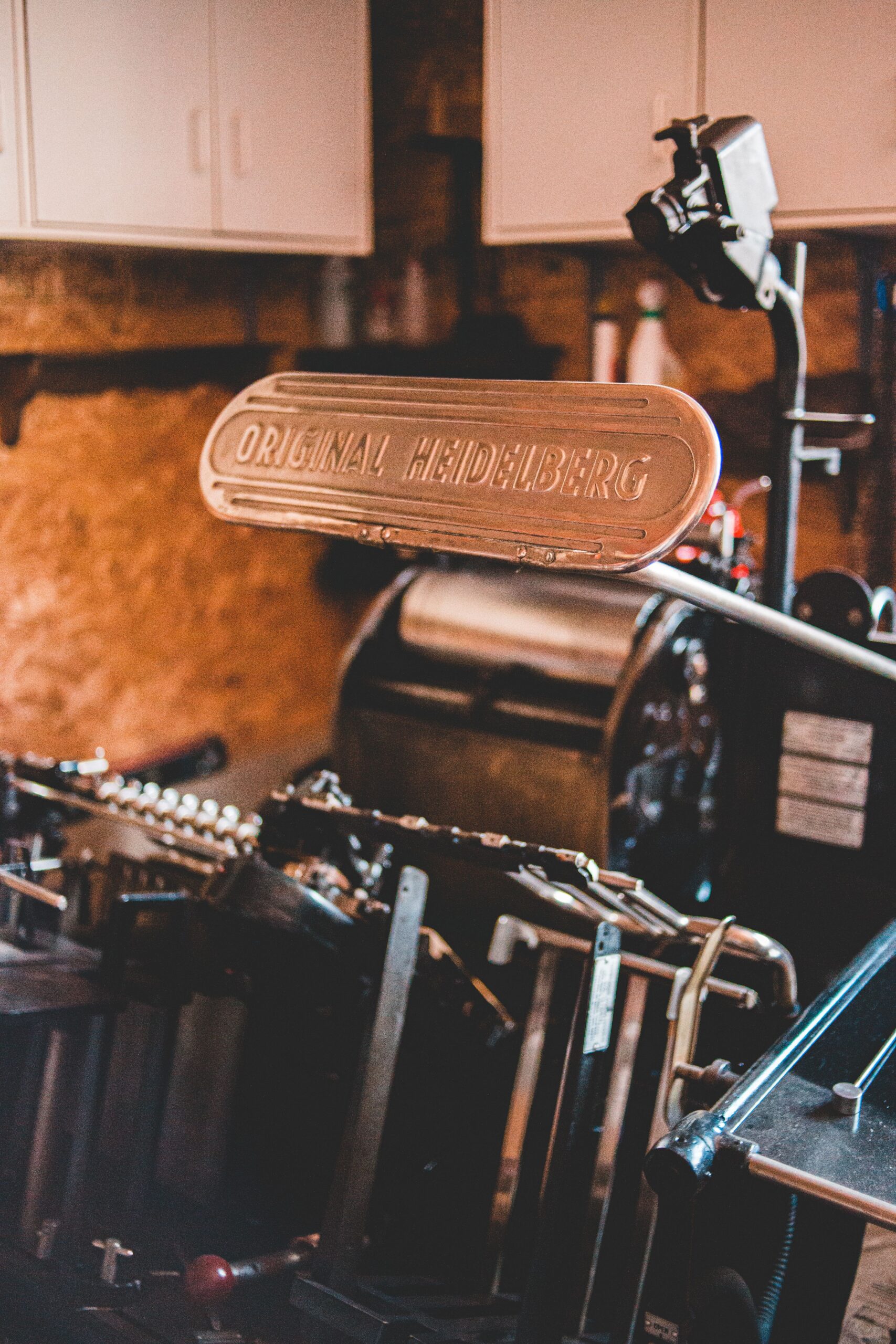 Old fashioned steel printing press machine installed in modern typography printing workshop